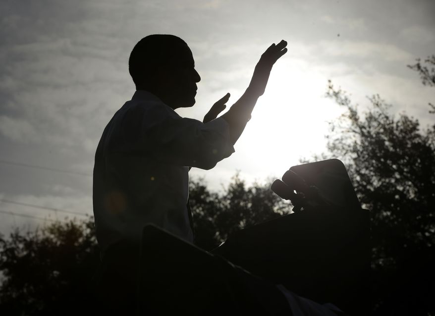 A silhouetted President Obama speaks Oct. 25, 2012, at a campaign event in Tampa, Fla. (Associated Press)