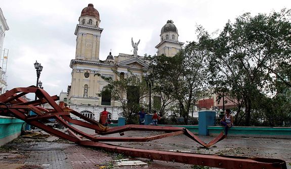 A fallen placard lies on the ground after the passing of Hurricane Sandy in Santiago de Cuba, Cuba, on Oct. 25, 2012. Hurricane Sandy blasted across eastern Cuba as a potent Category 2 storm and headed for the Bahamas after causing at least two deaths in the Caribbean. (Associated Press)