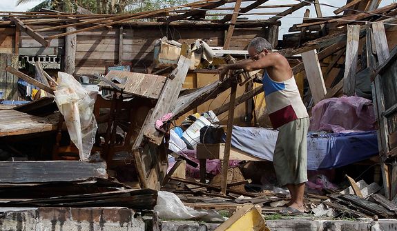 Resident Antonio Garces tries to recover his belongings from his house, destroyed by Hurricane Sandy, in Aguacate, Cuba, on Oct. 25, 2012. Hurricane Sandy blasted across eastern Cuba as a potent Category 2 storm and headed for the Bahamas after causing at least two deaths in the Caribbean. (Associated Press)
