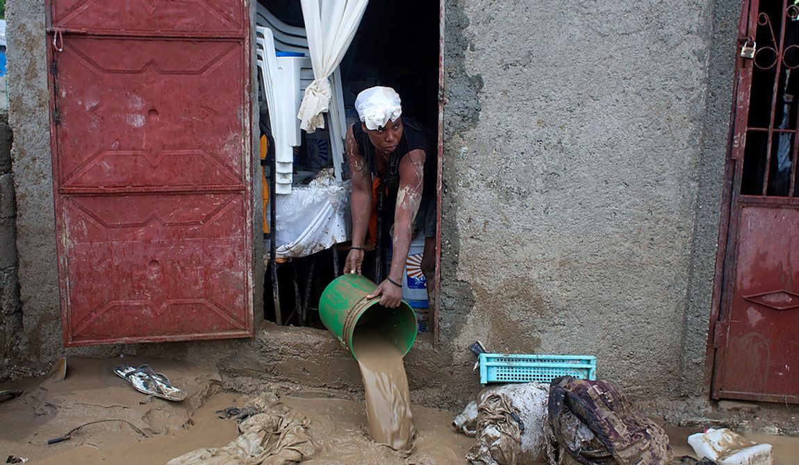 A resident drains mud from a flooded house after heavy rains brought by Hurricane Sandy in Port-au-Prince, Haiti, on Oct. 25, 2012. Sandy was blamed for the death of an elderly man in Jamaica who was crushed by a boulder. Another man and two women died while trying to cross storm-swollen rivers in southwestern Haiti. (Associated Press)