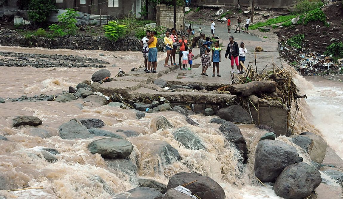 Residents stand Oct. 25, 2012, on a bridge that was previously destroyed in 2008 by Tropical Storm Gustav, while watching Hope River swell in the village of Kintyre, near Kingston, Jamaica, after the passing of Hurricane Sandy. (Associated Press)