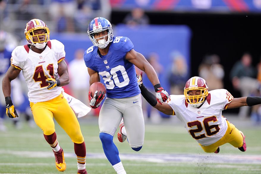 New York Giants wide receiver Victor Cruz (80) runs past Washington Redskins free safety Madieu Williams (41) and a diving cornerback Josh Wilson (26) on his way to a 77-yard game-winning touchdown late in the fourth quarter at MetLife Stadium, East Rutherford, N.J., Oct. 21, 2012. (Preston Keres/Special to The Washington Times)