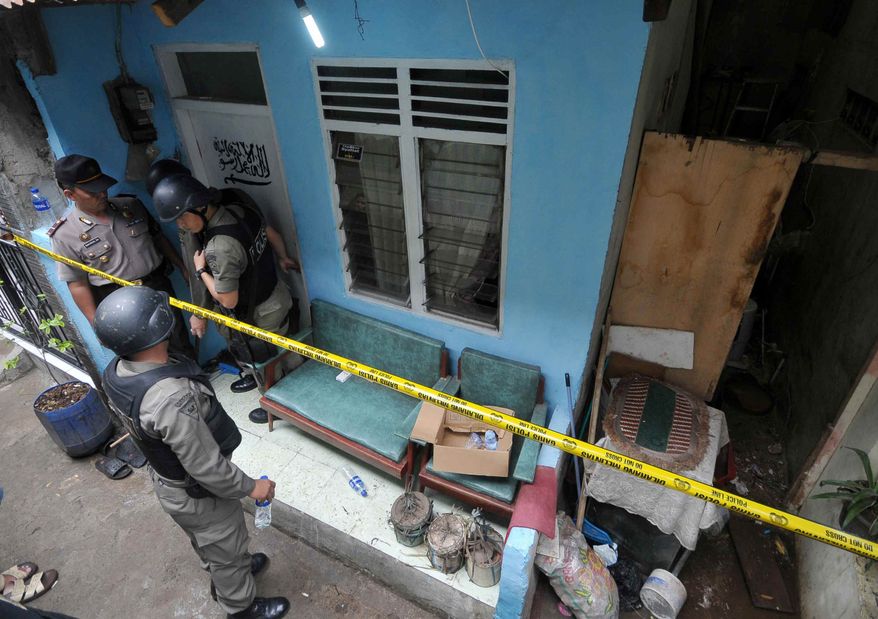 Indonesian police officer stand guard outside the house of a suspected terrorist after a raid in Jakarta, Indonesia, Saturday, Oct. 27, 2012. Indonesian police say they have arrested 11 people suspected of planning a range of terrorist attacks on domestic and foreign targets including the U.S. and Australian embassies. (AP Photo/Jefta)