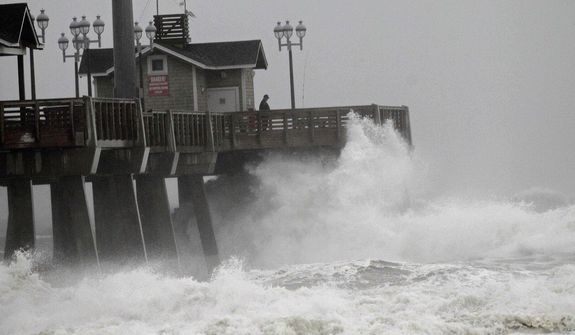 Large waves generated by Hurricane Sandy crash into Jeanette&#39;s Pier in Nags Head, N.C., Saturday, Oct. 27, 2012, as the storm moves up the East Coast. (AP Photo/Gerry Broome)

