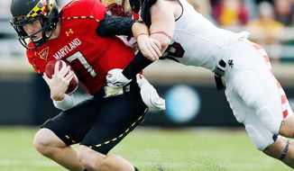 associated press
Maryland quarterback Caleb Rowe is tackled by Boston College linebacker Tim Joy on Saturday. Making his first start, Rowe completed 23 of 42 passes for 240 yards, two touchdowns and three interceptions during Maryland’s 20-17 loss.