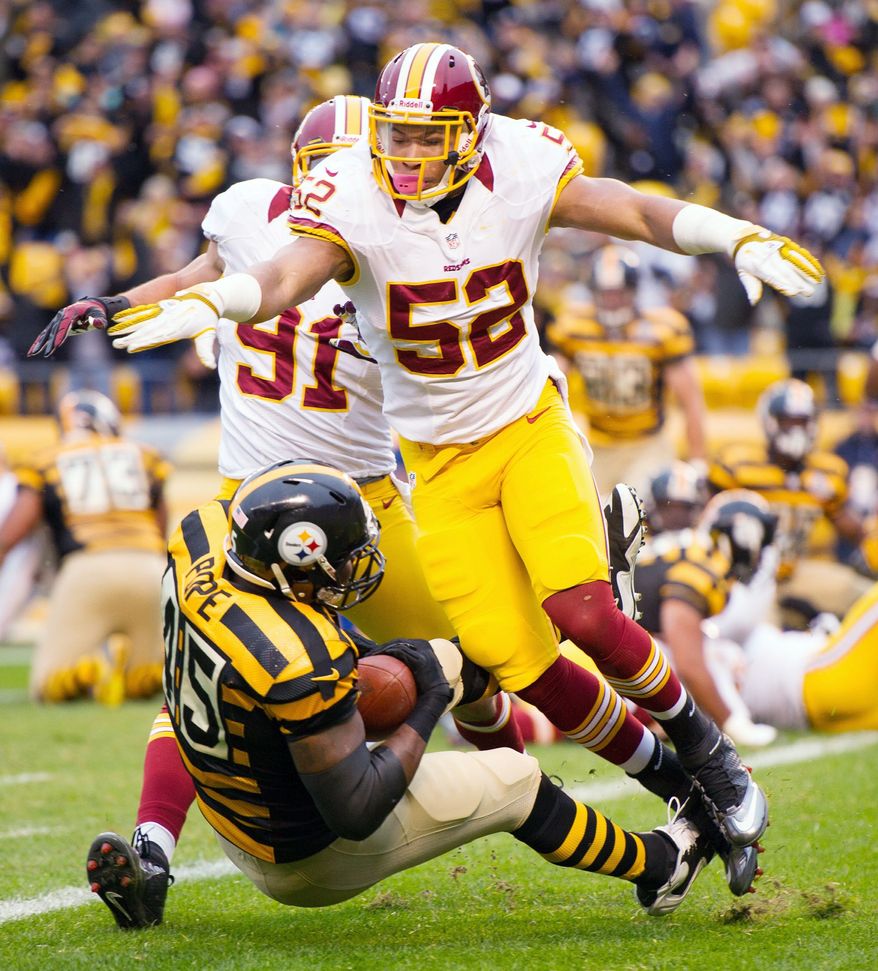 With Redskins linebackers Keenan Robinson (52) and Ryan Kerrigan trailing, Steelers tight end Leonard Pope falls into the end zone for the first score of the game. The touchdown catch on fourth-and-goal from the 1 cappeda 12-play, 76-yard drive during the first quarter. (Andrew Harnik/The Washington Times)