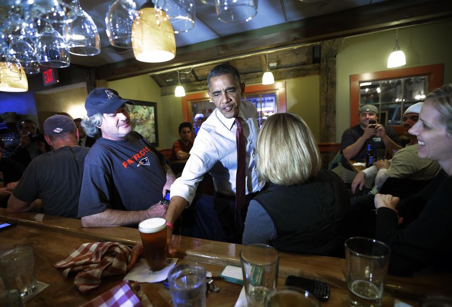 President Obama reaches for his beer on the bar as he greets patrons during an unscheduled visit to the Common Man Merrimack restaurant on Saturday, Oct. 27, 2012, in Merrimack, N.H. (AP Photo/Pablo Martinez Monsivais)