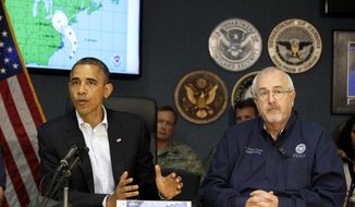 President Obama (left) attends a briefing with Federal Emergency Management Agency Administrator Craig Fugate at the National Response Coordination Center at FEMA headquarters in Washington on Sunday, Oct. 28, 2012. (AP Photo/Jacquelyn Martin)
