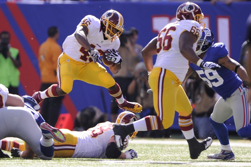 Washington Redskins running back Alfred Morris (46) leaps over the line during a first quarter carry against the Giants at MetLife Stadium, East Rutherford, N.J., Oct. 21, 2012. (Preston Keres/Special to The Washington Times)