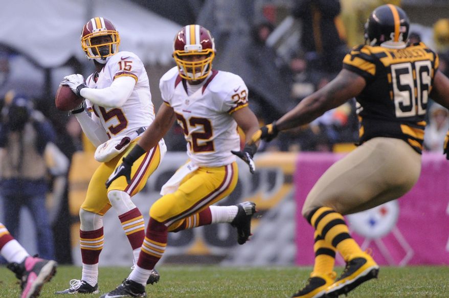 Washington Redskins wide receiver Josh Morgan (15) looks to pass to quarterback Robert Griffin III (10) on a trick play in the second quarter at Heinz Field, Pittsburgh, Pa., Oct. 28, 2012. (Preston Keres/Special to The Washington Times)