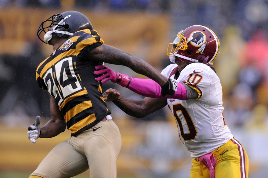 Washington Redskins quarterback Robert Griffin III (10) is called for offensive pass interference against Pittsburgh Steelers cornerback Ike Taylor (24) on this second quarter pass by wide receiver Josh Morgan at Heinz Field, Pittsburgh, Pa., Oct. 28, 2012. (Preston Keres/Special to The Washington Times)