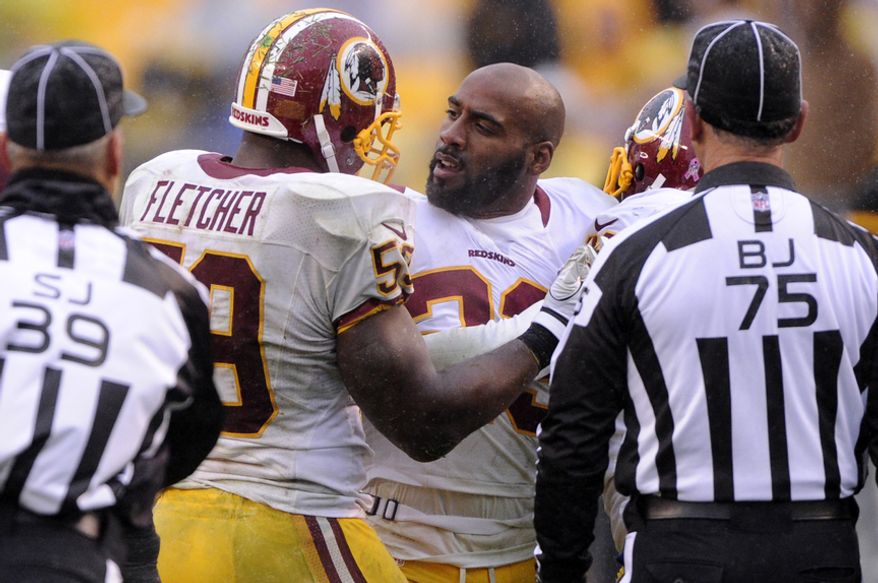 Washington Redskins cornerback DeAngelo Hall (23) is held back by London Fletcher (59) after being ejected from the game in the fourth quarter at Heinz Field, Pittsburgh, Pa., Oct. 28, 2012. (Preston Keres/Special to The Washington Times)