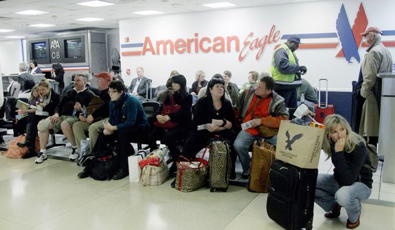 Passengers wait for their flight at at LaGuardia airport, Sunday, Oct. 28, 2012 in New York. Tens of thousands of residents were ordered to evacuate coastal areas Sunday as big cities and small towns across the Northeast buttoned up against the onslaught of a superstorm (AP Photo/Mary Altaffer)