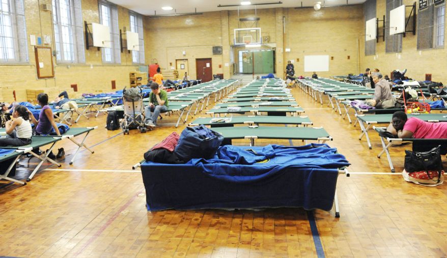 A public shelter in Seward Park High School on the lower east side begins to fill in preparation of the storm in New York. (AP Photo/ Louis Lanzano)