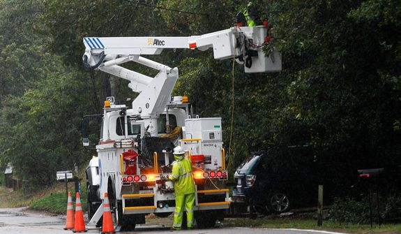 **FILE** Utility workers with Dominion repair damaged lines (AP Photo/Gerry Broome)