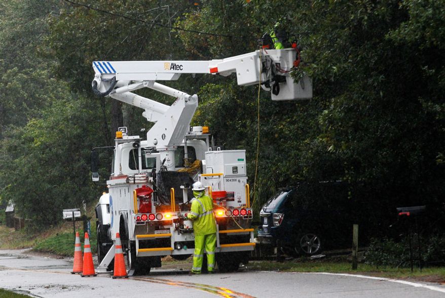 **FILE** Utility workers with Dominion repair damaged lines (AP Photo/Gerry Broome)