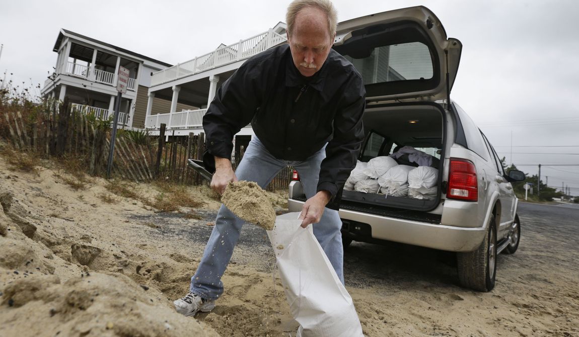 Mike Strobel fills sandbags for his business, Mike&#x27;s Carpet Connection, on Sunday, Oct. 28, 2012, in Fenwick Island, Del., as Hurricane Sandy bears down on the Mid-Atlantic states. (AP Photo/Alex Brandon)