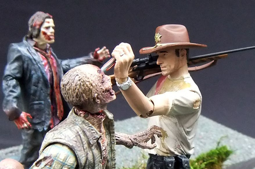 McFarlane Toys' RV Zombie meets his demise at the hands of Deputy Rick Grimes from The Walking Dead. (Photograph by Joseph Szadkowski / The Washington Times)
