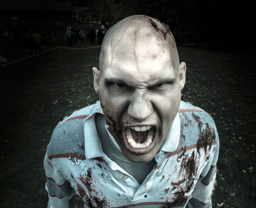 Michael Cosidine, from Bel Air, Md., puts on his best zombie face at Run for Your Lives, a zombie infested 5k obstacle course run, in Darlington, MD. (Andrew S. Geraci/The Washington Times)