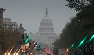 Pennsylvania Avenue is not its usual bumper-to-bumper busy on Monday morning as heavy rain from Hurricane Sandy arrives in Washington. With many hunkered down at home, the commute was easier for those who did venture out. (Associated Press)