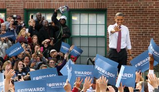President Obama greets supporters as he arrives for a campaign event at the Elm Street Middle School in Nashua, N.H., on Saturday, Oct. 27, 2012. (AP Photo/Jim Cole)
