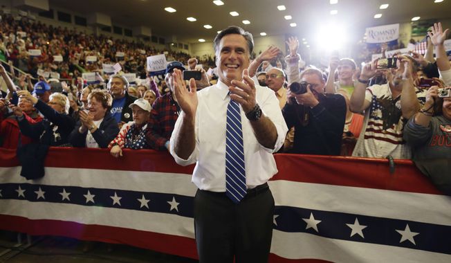 Republican presidential candidate Mitt Romney applauds as he watches the Oak Ridge Boys perform as he campaigns at the Veterans Memorial Coliseum at the Marion County Fairgrounds in Marion, Ohio, on Sunday, Oct. 28, 2012. (AP Photo/Charles Dharapak)