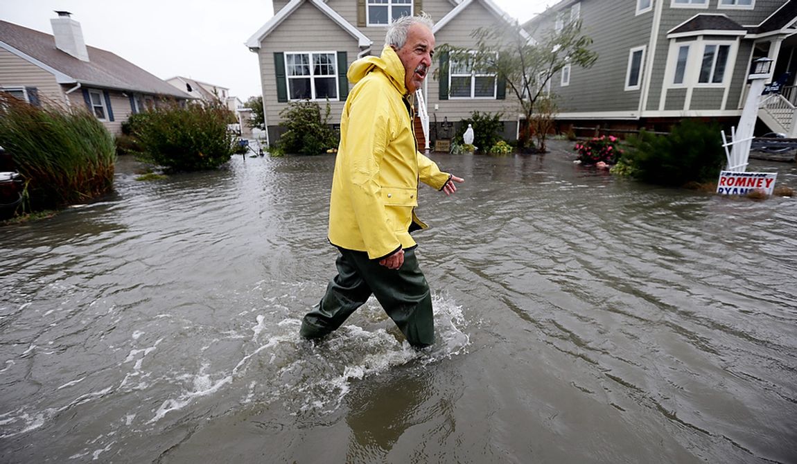 Richard Thomas walks through the floodwaters in front of his home after assisting neighbors as Hurricane Sandy bears down on the East Coast, on Monday, Oct. 29, 2012, in Fenwick Island, Del. Forecasters warned that the New York City region could face the worst of Sandy as it bore down on the Eastern Seaboard&#x27;s largest cities Monday, forcing the shutdown of financial markets and mass transit, sending coastal residents fleeing and threatening high winds, rain and a wall of water up to 11 feet high. It could endanger up to 50 million people for days. (AP Photo/Alex Brandon)