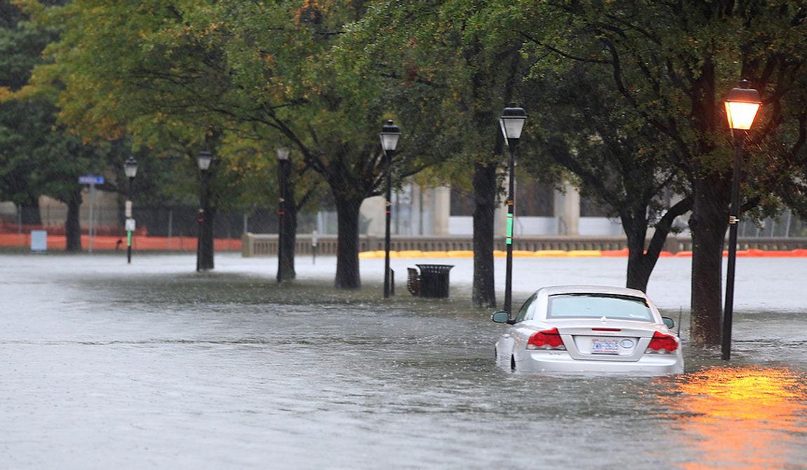 A stranded car sits along a street near downtown Norfolk, Va., on Monday, Oct. 29, 2012. Rain and wind from Hurricane Sandy were hitting the area. (AP Photo/Steve Helber)