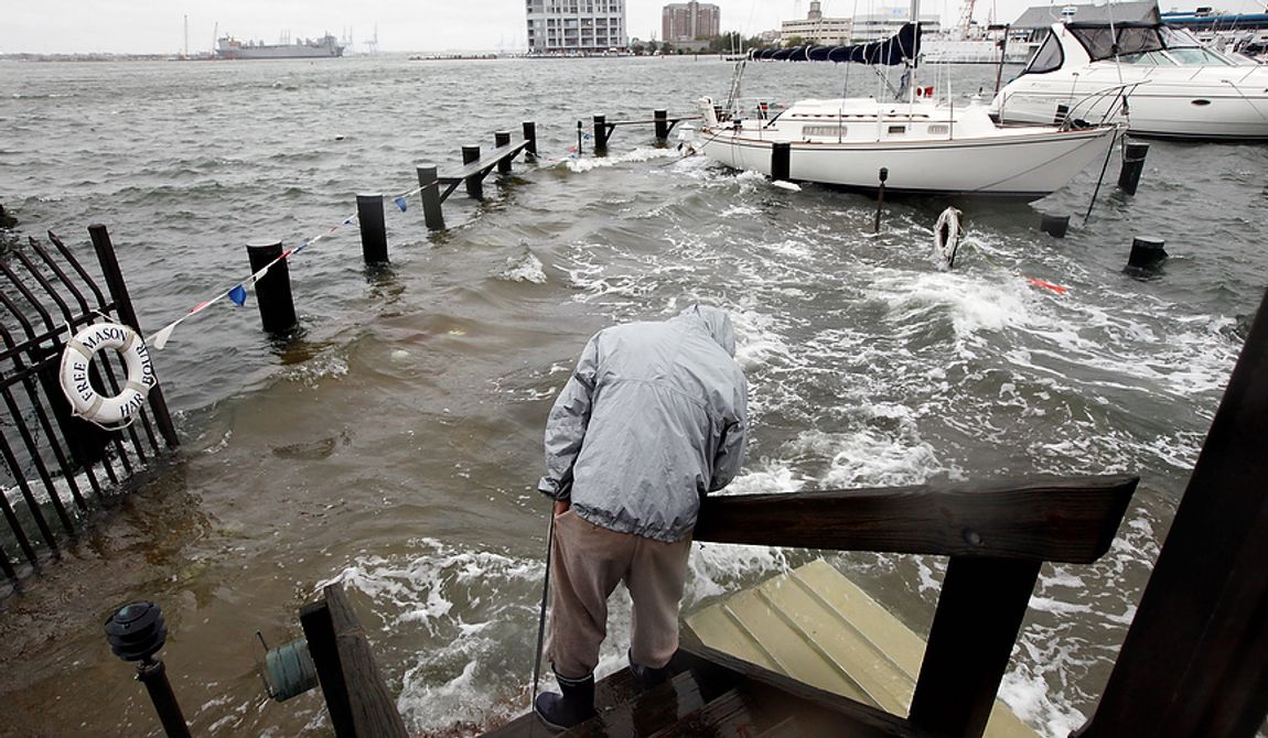 Norfolk, Va., resident Jack Devnew looks at the water covering a dock as he checks on his boat at a marina near downtown on Monday, Oct. 29, 2012. Rain and wind from Hurricane Sandy were hitting the area. (AP Photo/Steve Helber)