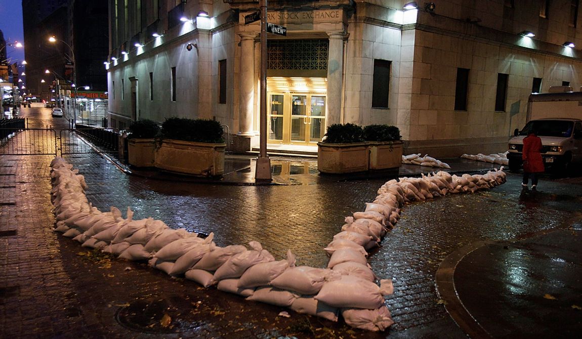 Sandbags protect an entrance of the New York Stock Exchange on Monday, Oct. 29, 2012. Hurricane Sandy continued on its path Monday, forcing the shutdown of mass transit, schools and financial markets; sending coastal residents fleeing; and threatening a dangerous mix of high winds and soaking rain. There had been plans to allow electronic trading to go forward on the NYSE, but with a storm surge expected to cover parts of lower Manhattan in floodwaters, officials decided late Sunday that it was too risky to ask any personnel to staff the exchanges. (AP Photo/Richard Drew)