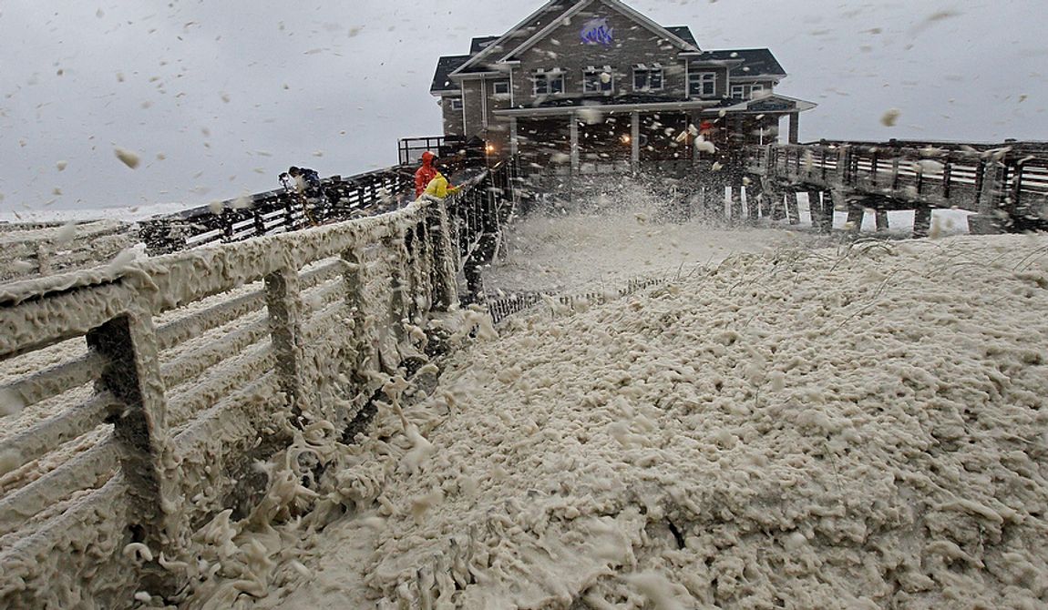 High winds blow sea foam onto Jeanette&#x27;s Pier in Nags Head, N.C., on Sunday, Oct. 28, 2012, as wind and rain from Hurricane Sandy move into the area. Governors from North Carolina, where steady rains were whipped by gusting winds Saturday night, to Connecticut declared states of emergency. Delaware ordered mandatory evacuations for coastal communities by 8 p.m. Sunday. (AP Photo/Gerry Broome)
