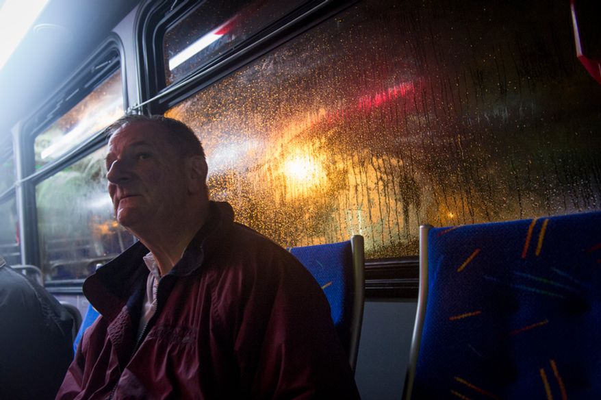 Lee Strom waits on a city bus to be taken to a shelter at the Lee District RECenter in Franconia, Va., during a mandatory evacuation order in the Huntington neighborhood of Alexandria, Va., Monday, Oct. 29, 2012, while high winds and heavy rain from Hurricane Sandy pound the Atlantic coast. Mr. Strom's home is on Arlington Terrace. (Rod Lamkey Jr./The Washington Times)