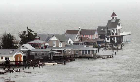 A row of houses stands in floodwaters at Grassy Sound in North Wildwood, N.J., as Hurricane Sandy pounds the East Coast Monday Oct. 29, 2012.  (AP Photo/The Press of Atlantic City, Dale Gerhard) 