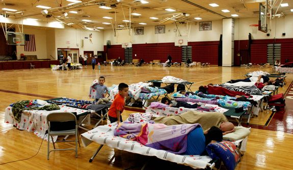 A few dozen people take refuge from Hurricane Sandy at a Red Cross shelter, Monday, Oct. 29, 2012, in Deer Park, N.Y. (AP Photo/Jason DeCrow)