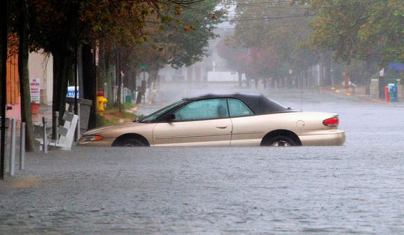 A car is stuck in deep water on Wilmington Avenue in Rehoboth Beach, Del., Monday, Oct. 29, 2012. (AP Photo/The Wilmington News-Journal, Suchat Pederson)  