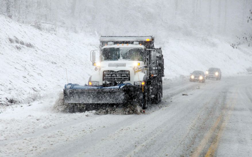 Snow plows move through the mountains of West Virginia Monday, Oct. 29, 2012, in Randolph County, W.Va. Sandy was set to collide with a wintry storm from the west and cold air streaming down from the Arctic. The combination superstorm could menace some 50 million people in the most heavily populated corridor in the nation, from the East Coast to the Great Lakes. (AP Photo/Robert Ray)