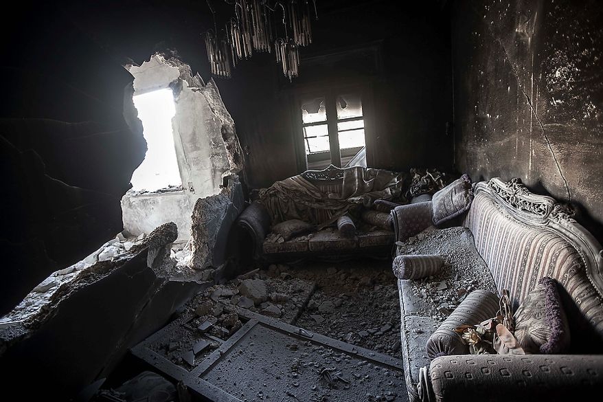 An apartment destroyed by tank shelling is seen in the Karm al-Jabel neighborhood of Aleppo, Syria, on Sunday, Oct. 28, 2012, after several days of intense clashes between rebel fighters and the Syrian army. Syria's air force fired missiles and dropped barrel bombs on rebel strongholds while opposition fighters attacked regime positions, flouting a U.N.-backed cease-fire that was supposed to quiet fighting over a long holiday weekend but never took hold. (AP Photo/Narciso Contreras)