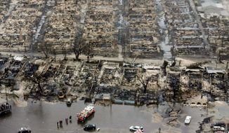Burned homes in the Breezy Point section of the Queens borough New York show the destruction Tuesday. The beachfront neighborhood was told to evacuate before superstorm Sandy. It was wracked with fire and flooding at the same time. (Associated Press)