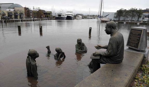 The Kunta Kinte-Alex Haley Memorial sits in flood waters in downtown Annapolis, Md., Tuesday, Oct. 30, 2012, after the superstorm and the remnants of Hurricane Sandy passed through Annapolis. (AP Photo/Susan Walsh)