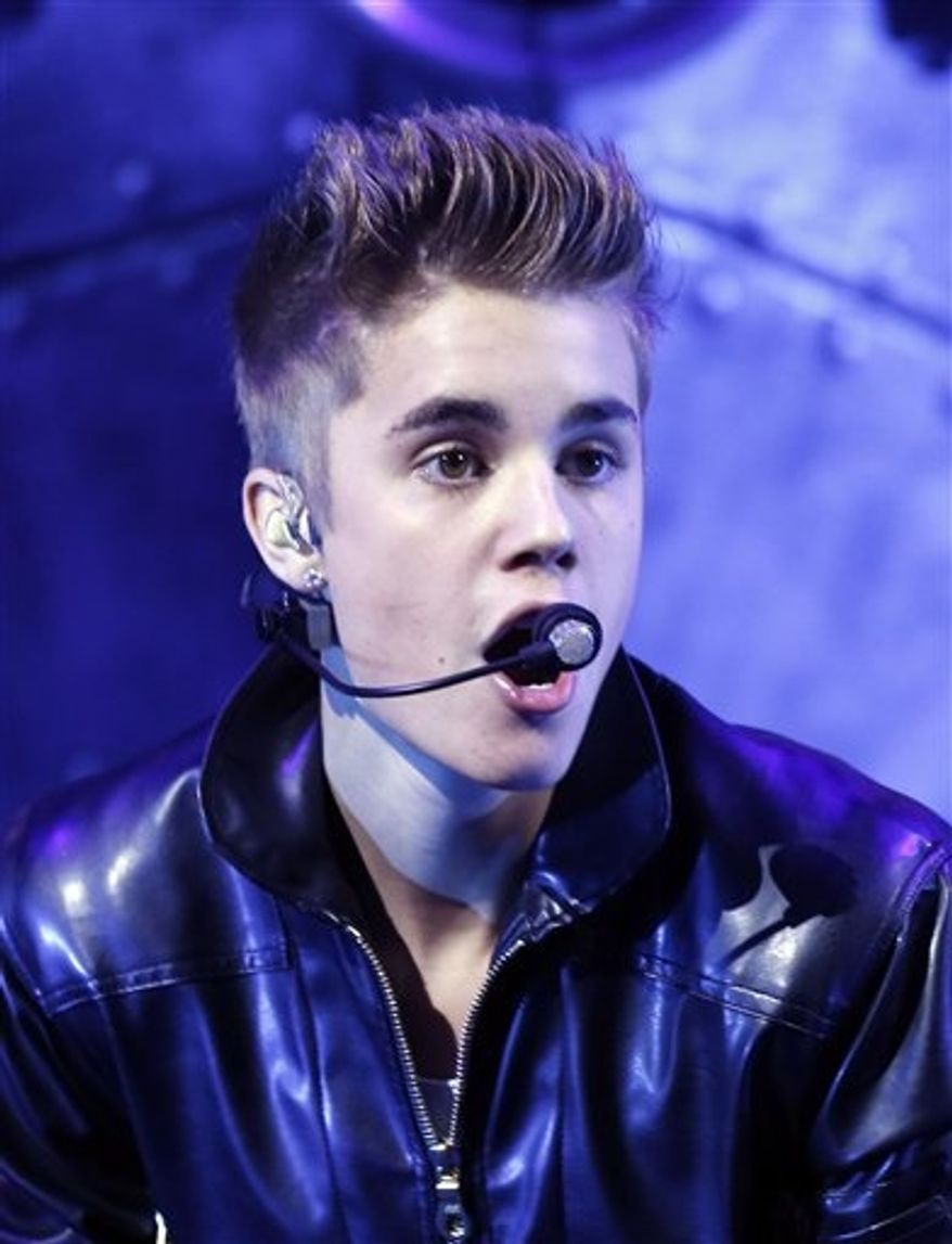 ** FILE ** This Sept. 30, 2012, file photo shows Justin Bieber performing at the MGM Grand Garden Arena in Las Vegas. (Photo by Isaac Brekken/Invision/AP, file)