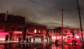 Firefighters battle a blaze on Rockaway Beach Boulevard in the borough of Queens on Tuesday, Oct. 30, 2012, in New York. (AP Photo/Frank Franklin II)