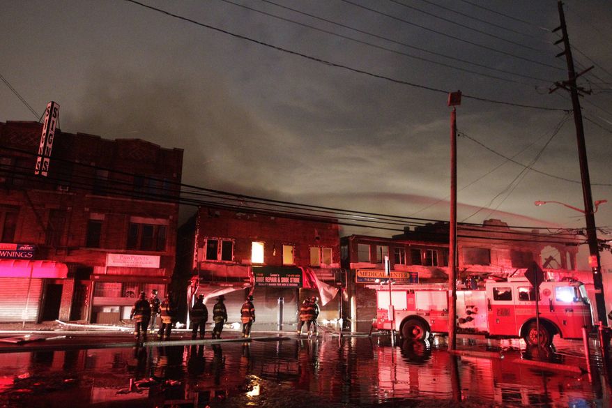 Firefighters battle a blaze on Rockaway Beach Boulevard in the borough of Queens on Tuesday, Oct. 30, 2012, in New York. (AP Photo/Frank Franklin II)