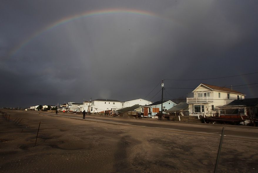 A rainbow forms over Breezy Point in the New York City borough of Queens, in the aftermath of superstorm Sandy, Tuesday, Oct. 30, 2012, in New York. The fire destroyed between 80 and 100 houses Monday night in the flooded neighborhood. (AP Photo/Frank Franklin II)