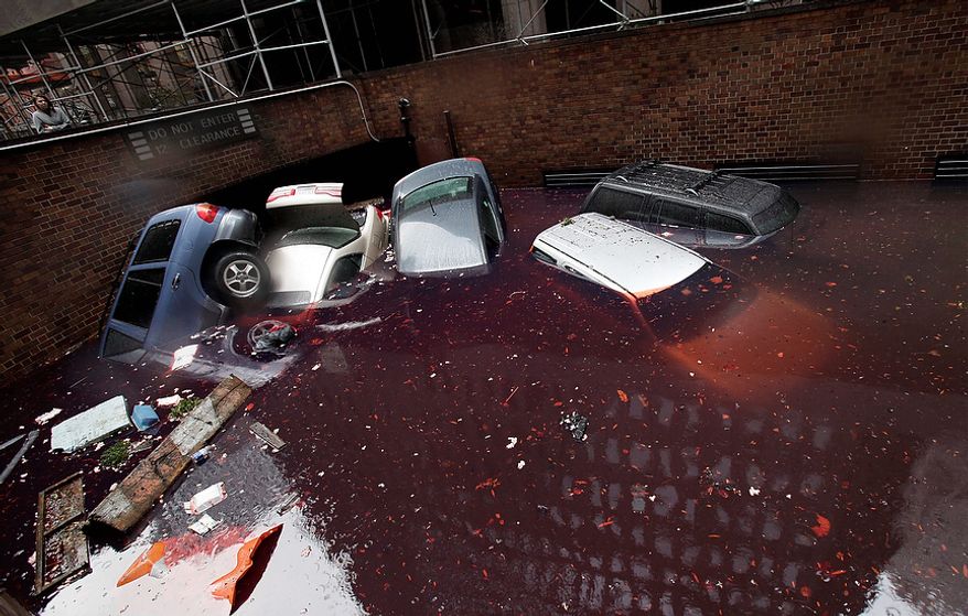 Cars are submerged at the entrance to a parking garage in New York's Financial District in the aftermath of superstorm Sandy, Tuesday, Oct. 30, 2012. New York City awakened Tuesday to a flooded subway system, shuttered financial markets and hundreds of thousands of people without power a day after a wall of seawater and high winds slammed into the city, destroying buildings and flooding tunnels. (AP Photo/Richard Drew)