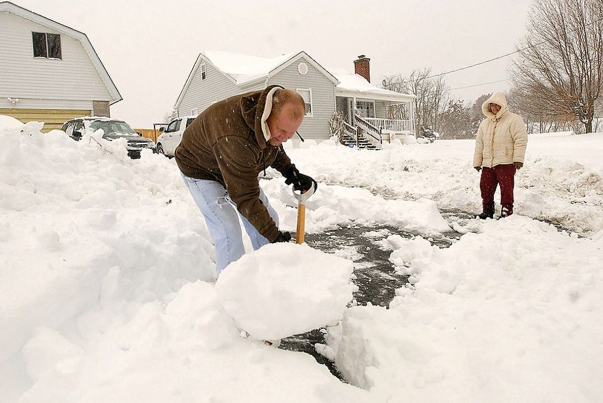Joe and Linda Bays shovel snow in front of their home in Beckley, W.Va. on Tuesday, Oct. 30, 2012. The storm that hit late Monday and into Tuesday dumped up to 19 inches of snow in West Virginia, cutting electricity to about 271,000 customers and closing dozens of roads. One storm-related death was reported. (AP Photo/Jon C. Hancock)