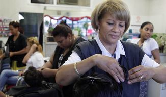 Milagros Rodriguez, from the Dominican Republic, works at her salon, Woodside Beauty Salon in Queens, N.Y. A study says two-thirds of job growth since 2009 has been among immigrants. (Associated Press)