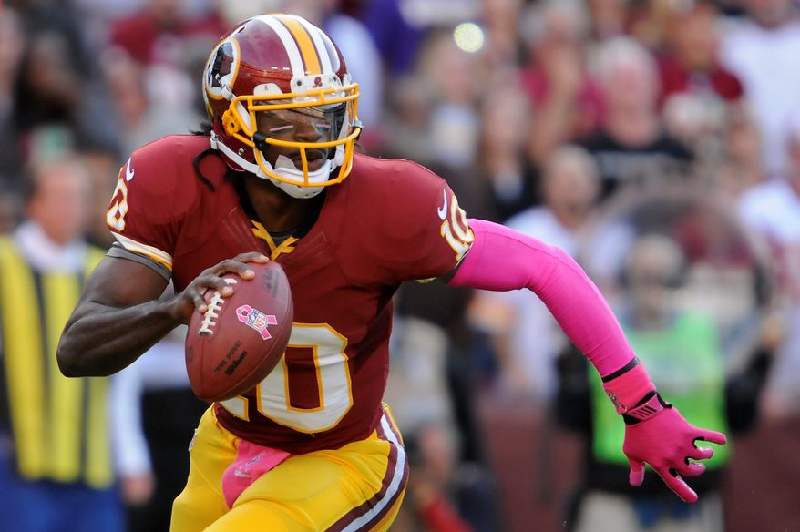 Washington Redskins quarterback Robert Griffin III (10) scrambles out of the pocket before throwing an interception in the first quarter at FedEx Field, Landover, Md., Oct. 14, 2012. (Preston Keres/Special to The Washington Times)