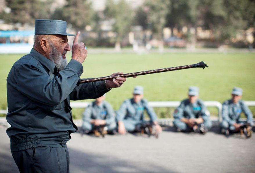 Afghan National Police instructor Ghulam Hazrat, left, 70, instructs recruits at the police academy in Kabul, Afghanistan. On Thursday, Oct. 18, 2012, President Hamid Karzai said that his military and police are prepared to take full responsibility for security if the American-led international coalition decides to speed up the handover. But international observers warn that the largely illiterate police force will disintegrate after 2014 into factional militias more loyal to local warlords than to the state. (AP Photo/Anja Niedringhaus)