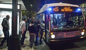 This photo provided by Metropolitan Transportation Authority shows people boarding a bus, as partial bus service was restored on Tuesday, Oct. 30, 2012. Mass transit, including buses, was suspended during Sandy, the storm that made landfall Monday. (AP Photo/Metropolitan Transportation Authority, Patrick Cashin)