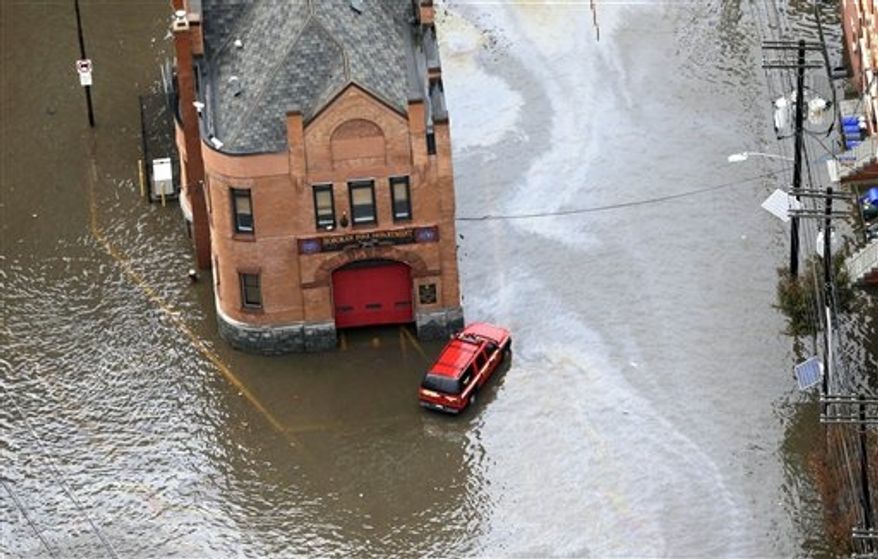 A firehouse is surrounded by floodwaters in the wake of superstorm Sandy on Tuesday, Oct. 30, 2012, in Hoboken, N.J. Sandy, the storm that made landfall Monday, caused multiple fatalities, halted mass transit and cut power to more than 6 million homes and businesses. (AP Photo/Mike Groll)